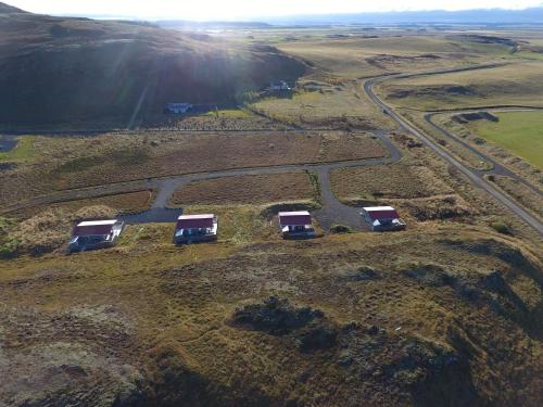 a group of camels parked on a field next to a road at Mosas cottages in Fludir