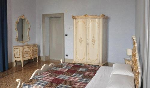 a bedroom with a bed and a dresser in it at Albergo Villa San Giuseppe in Noceto