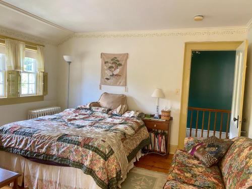 a bedroom with a bed and a chair in it at Artful Lodging & Retreats in Montpelier