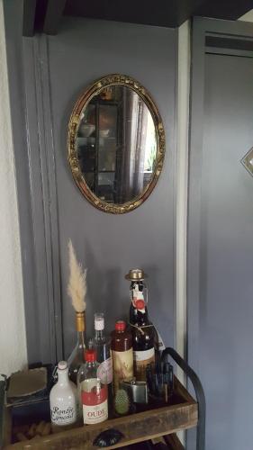 a table with a mirror and some bottles on it at Pension Abshoff in Meschede