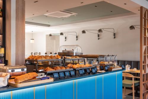 a buffet line with bread and pastries on display at Modica Boutique Hotel in Modica
