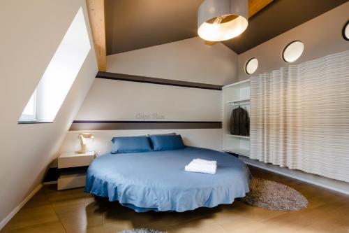 a bedroom with a bed with blue pillows at Lago Welcome Clausen II in Luxembourg
