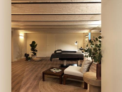 a living room with a piano and a couch at Townhouse Maastricht & Spa in Maastricht