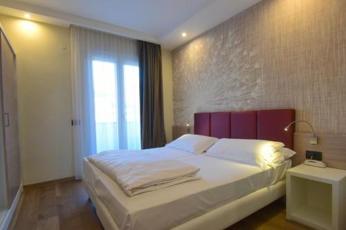 Ένα ή περισσότερα κρεβάτια σε δωμάτιο στο Hotel Virgilio