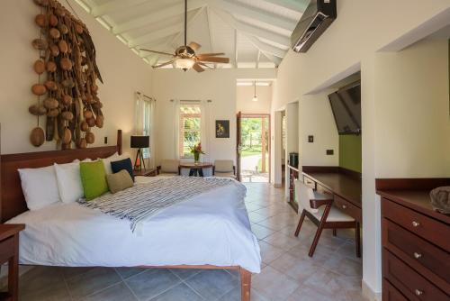 a bedroom with a bed and a desk and a television at Ka'ana Resort & Spa in San Ignacio
