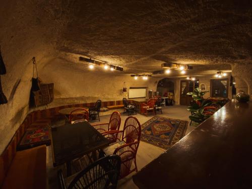 a room with tables and chairs in a cave at Asteria Cave Hotel in Goreme