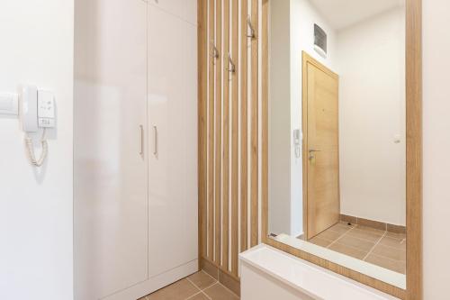 a bathroom with a mirror and a sink at Piskalina Apartment in Tivat