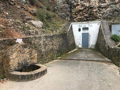 a garage with a door in the side of a mountain at CA LIDIA - Apartamentos Turisticos EL BALCONET in Benimantell