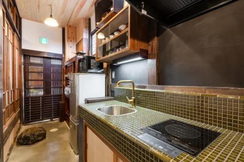 a kitchen with a sink and a counter top at Yamagata Kyomachihatago Kyotostation Mae in Kyoto