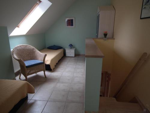 a small bedroom with a bed and a stair case at Lindenstrassee Haus Sonnengru_ in Zingst