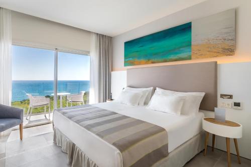 a bedroom with a bed and a view of the ocean at Barceló Conil Playa - Adults Recommended in Conil de la Frontera