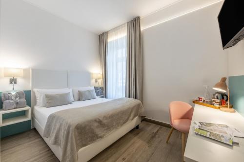 a hotel room with a bed and a window at Maison Valentina in Merano