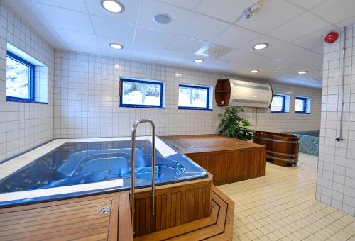 a large bathroom with a large blue tub at Lägenhetshotell Varvet in Ellös