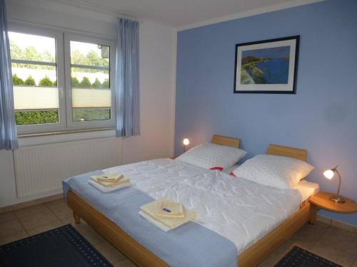 a bedroom with a bed with two towels on it at Neue Liebe - Wohnung 1 in Groß Kirr
