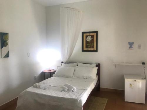 a bedroom with a bed with a stuffed animal on it at Pousada Sonho Meu in Itanhandu