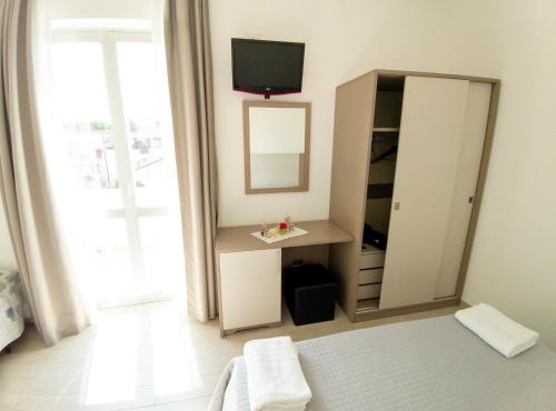 Postel nebo postele na pokoji v ubytování Hotel Capitano