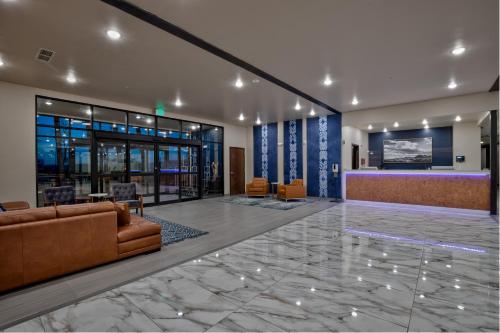 a lobby with a couch and a reception desk at Scenic View Inn & Suites Moab in Moab