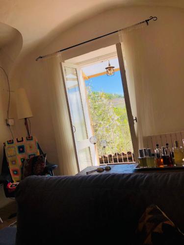 a room with a bed and an open window at I 5 Sensi Country in Brusnengo
