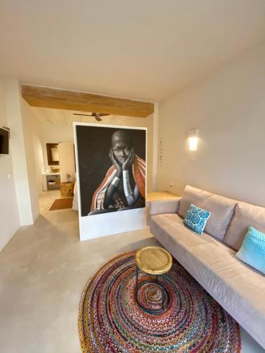 a living room with a couch and a rug at Boho Suites Denia in Denia