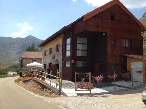 a brown building with a bridge in front of it at Alojamientos Casa San Habitaciónes in Besande