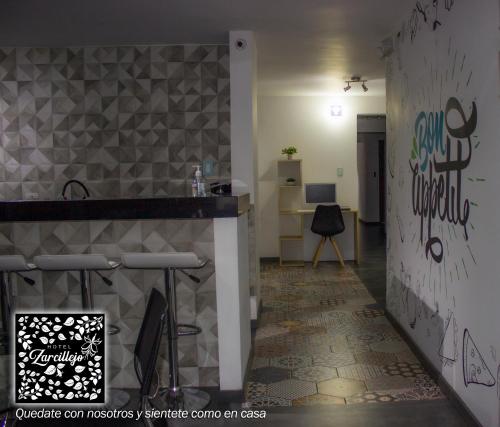 a room with a counter and a wall with graffiti at HOTEL ZARCILLEJO in Pasto