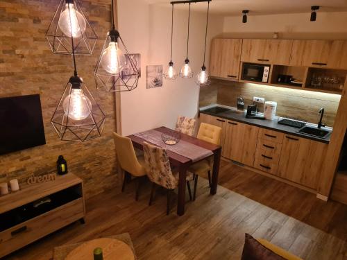 a kitchen and dining room with a table and chairs at Hedonic in Kopaonik
