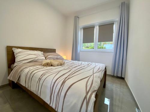 a dog laying on a bed in a bedroom at Villa Olga - Uniqe house with private beach in Ankaran