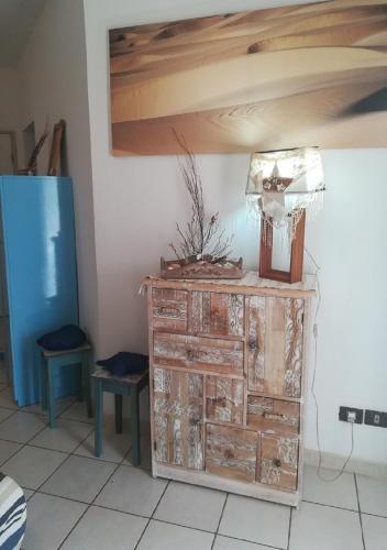 a wooden dresser in a room with two stools at Sea view house, Praia de Chaves, Boa Vista, Cape Verde, FREE WI-FI in Cabeçadas
