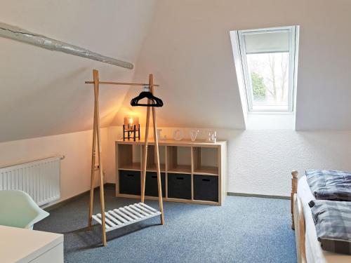 a bedroom with a room with a bed and a lamp at Smittshörn 3 - Oberdeck in Altfunnixsiel