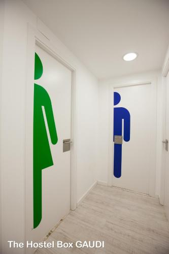 a white room with two doors with toilets at Rocket Hostels Gracia in Barcelona