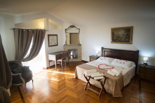 
a room with a bed, chair, table and a lamp at Residenza Kastrum in Cagliari
