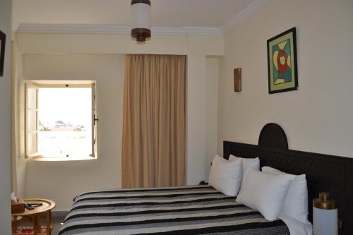 Postel nebo postele na pokoji v ubytování Hotel Riad Ben Atar