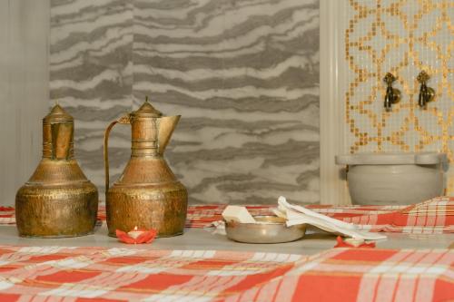 two copper vases sitting on a table with a table cloth at Hugo's Boutique Hotel - Adults Only in St Julian's