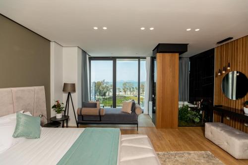 a bedroom with a bed and a living room at Ames Hotel & SPA in Vlorë