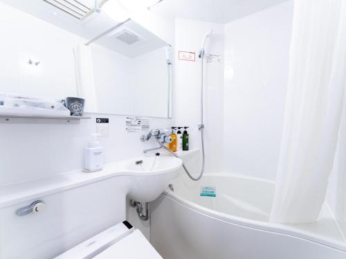 a white bathroom with a sink and a shower at APA Hotel Kyoto Gion Excellent in Kyoto