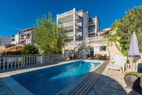 a swimming pool in front of a building at Apartment Crikvenica, Vinodol 10 in Sopaljska