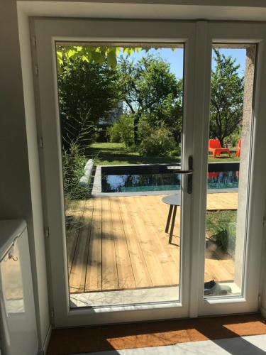 a sliding glass door with a view of a patio at Côté Verger in Vittel