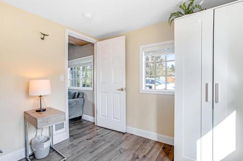 a hallway with a door and a table with a lamp at Siletz Bay Getaway in Lincoln City
