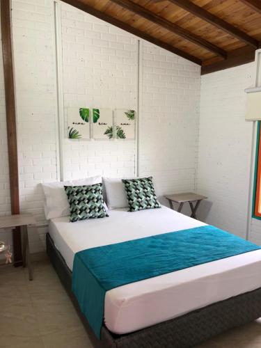 a bedroom with a large bed in a room at Cabañas Veracruz3 Cerritos in Pereira