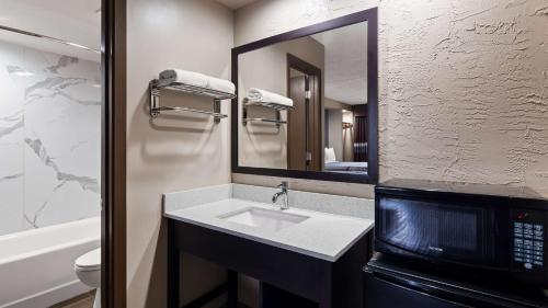 a bathroom with a sink and a mirror at SureStay Hotel by Best Western Jasper in Jasper
