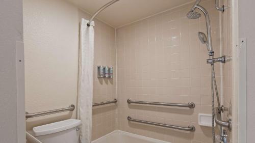 a bathroom with a shower and a toilet at Best Western Pony Soldier Inn & Suites in Flagstaff