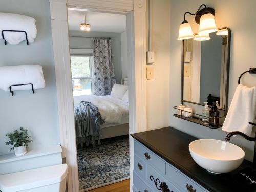 a bathroom with a sink and a mirror at Inn on Golden Pond in Holderness