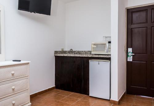 a kitchen with a counter and a microwave at The Palms At Coco Beach in Coco