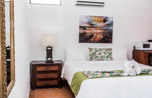 a bedroom with two beds and a mirror at The Palms At Coco Beach in Coco