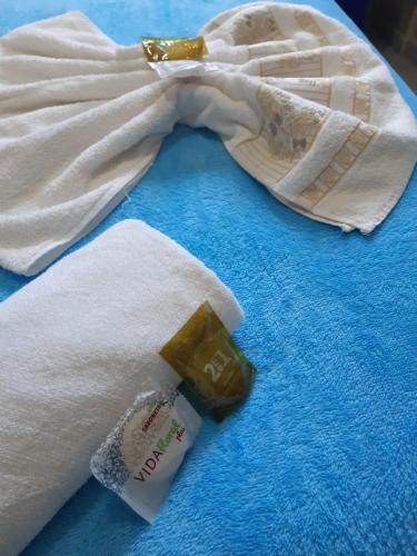 a bottle of soap sitting on top of a towel at Pousada Portal do Cabo in João Pessoa