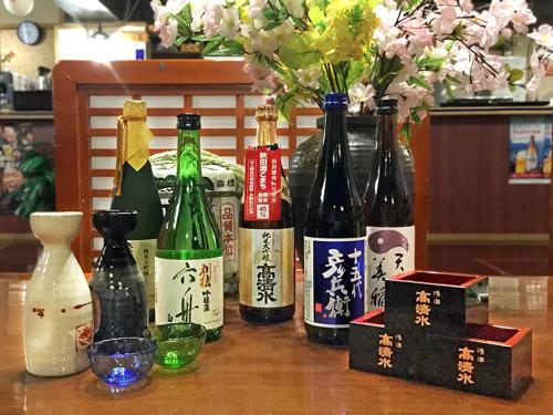 a group of bottles of wine sitting on a table at Ohmachiso in Akita