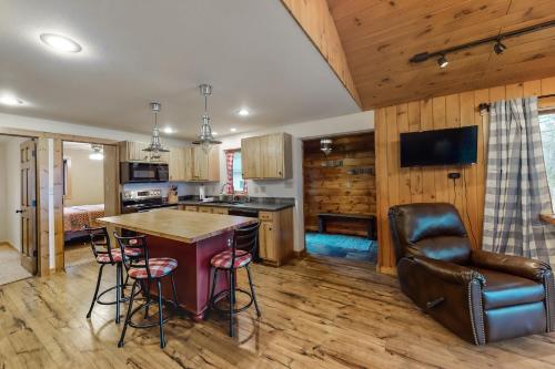 a kitchen and living room with a table and chairs at Whispering Pines in Harshaw