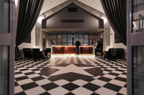 a man standing in a room with a star on the floor at Titanic Hotel Belfast in Belfast