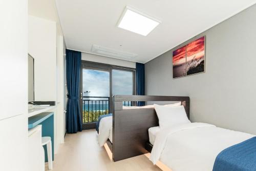 Postel nebo postele na pokoji v ubytování Risen Ocean Park Hotel