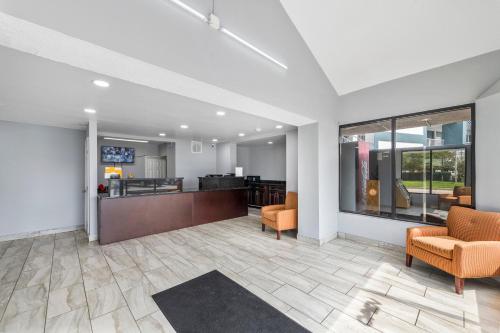 an empty lobby with chairs and a waiting room at Super 8 by Wyndham Portsmouth - Norfolk in Portsmouth